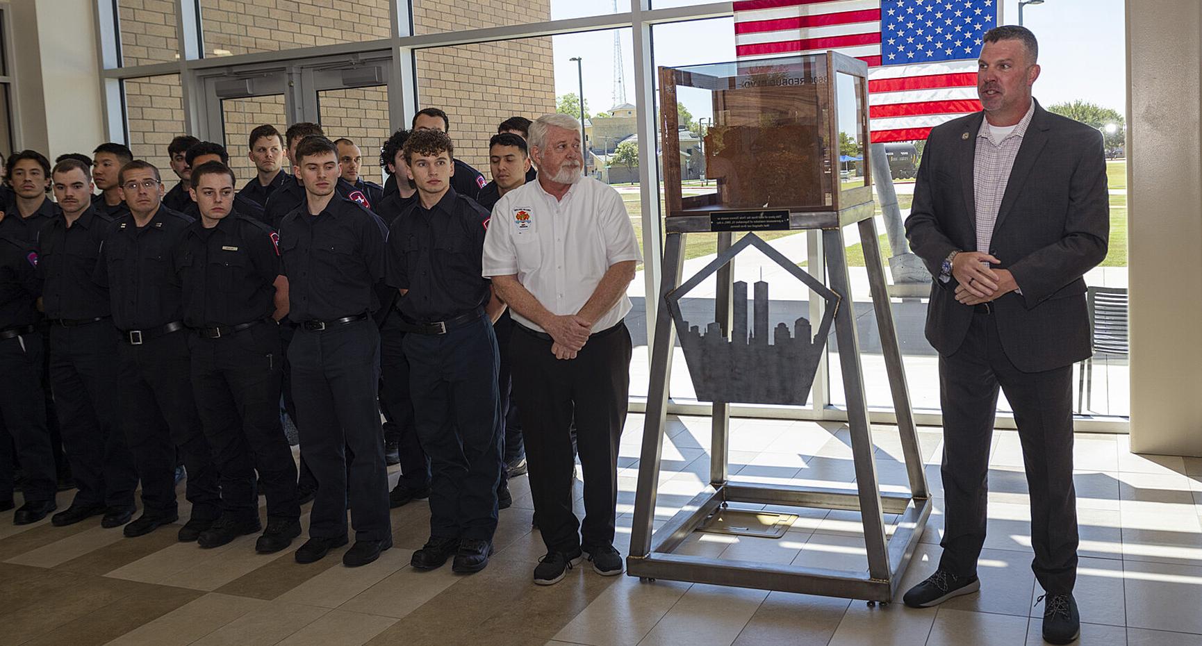 Law Enforcement Academy Director Scott Donaldson (left) and Fire Science Academy Director Pat McAuliff (right) stand next to the Sept. 11 memorial at the Collin College Public Safety Training Center in McKinney.